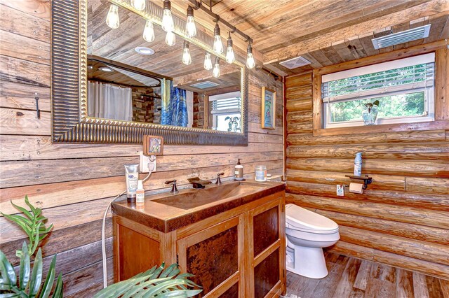 4126 Burrows Rd, Zephyrhills, FL 33542 - full bath featuring toilet, wooden ceiling, log walls, and plenty of natural light