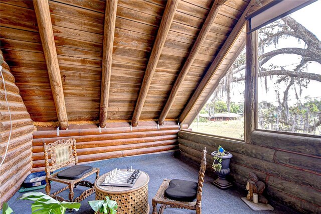 4126 Burrows Rd, Zephyrhills, FL 33542 - living area with wooden ceiling, rustic walls, carpet floors, and vaulted ceiling with beams