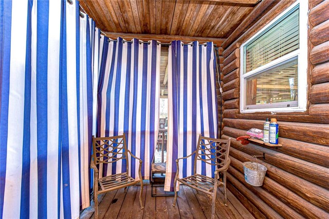 4126 Burrows Rd, Zephyrhills, FL 33542 - interior space featuring wood-type flooring, wooden ceiling, wallpapered walls, and log walls