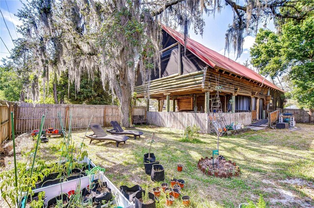 4126 Burrows Rd, Zephyrhills, FL 33542 - view of yard featuring a garden and a fenced backyard