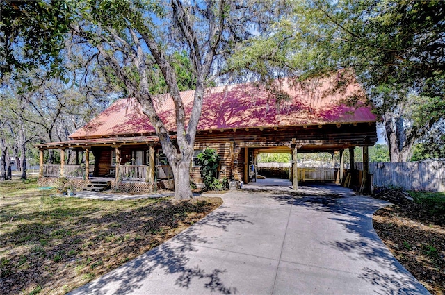 4126 Burrows Rd, Zephyrhills, FL 33542 - rustic home featuring fence, covered porch, concrete driveway, and metal roof