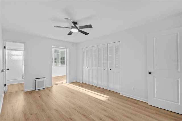 1225 58th St N Unit 204A, Saint Petersburg, FL 33710 - unfurnished bedroom featuring light wood-style floors, baseboards, a closet, and ensuite bath