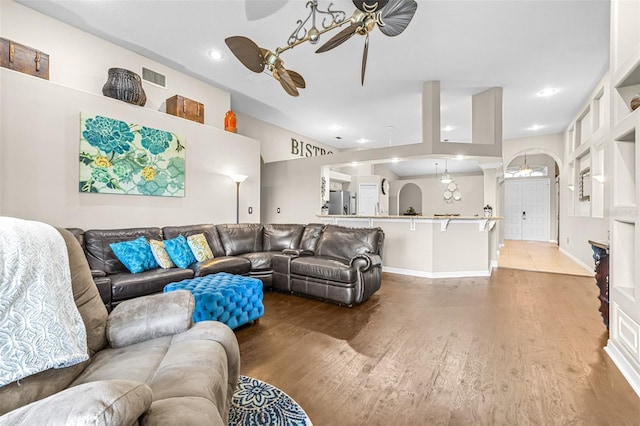 living room featuring visible vents, baseboards, recessed lighting, wood finished floors, and a ceiling fan