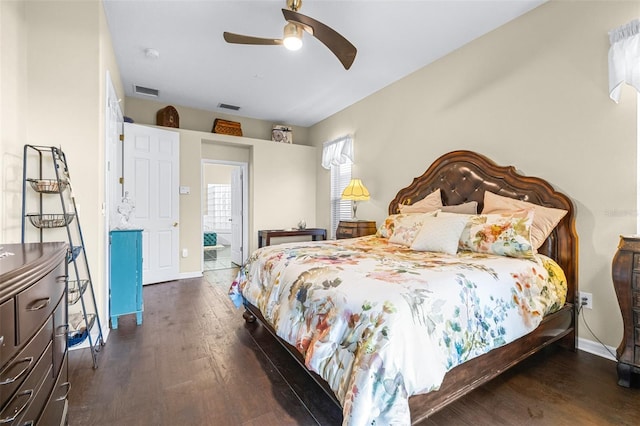 bedroom with dark wood-type flooring, visible vents, and baseboards
