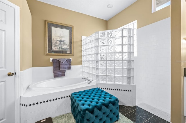 bathroom featuring a walk in shower and a garden tub