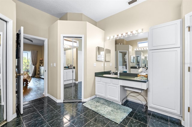 bathroom featuring visible vents, vanity, and baseboards