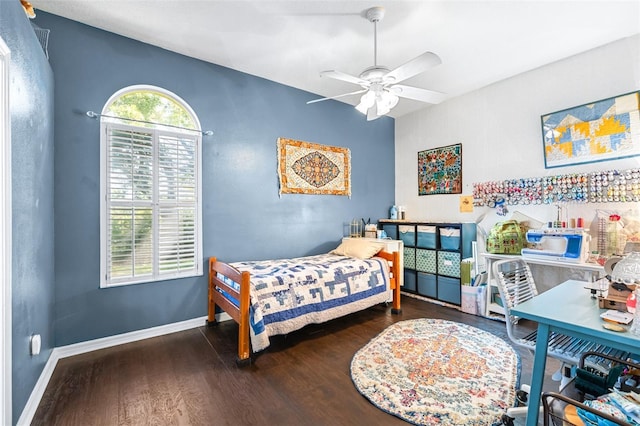 bedroom featuring wood finished floors, a ceiling fan, and baseboards