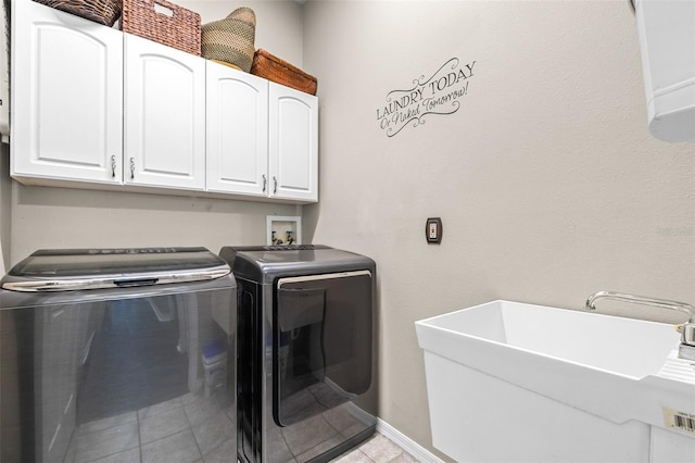 laundry room featuring a sink, cabinet space, washer and clothes dryer, light tile patterned floors, and baseboards