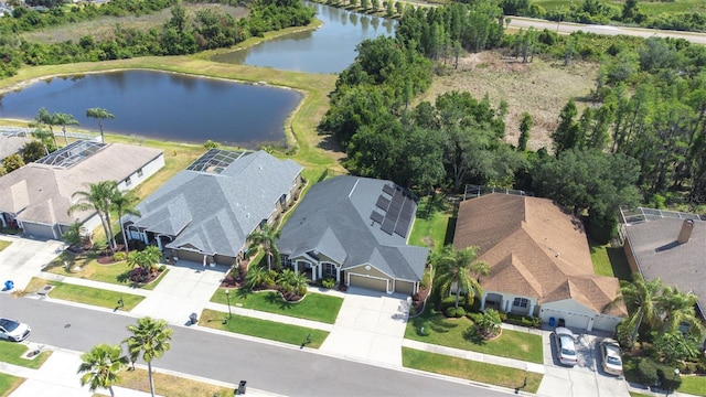 drone / aerial view featuring a residential view and a water view