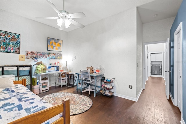 bedroom with baseboards, wood finished floors, a ceiling fan, and a textured wall