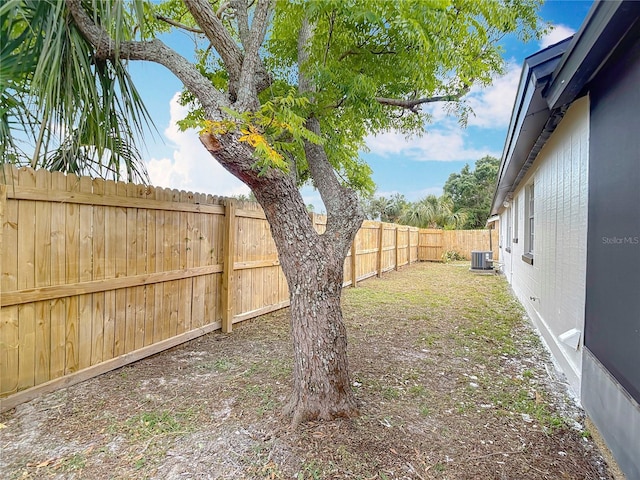 view of yard with cooling unit and a fenced backyard