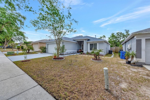 view of front of property with a garage, fence, a front yard, stucco siding, and concrete driveway