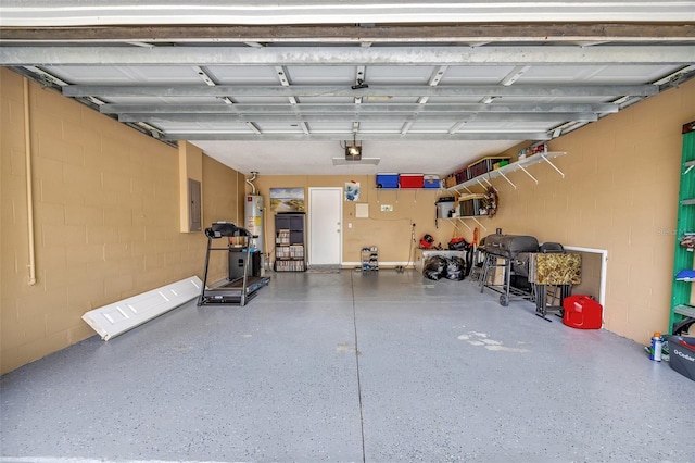 garage with a garage door opener, water heater, electric panel, and concrete block wall