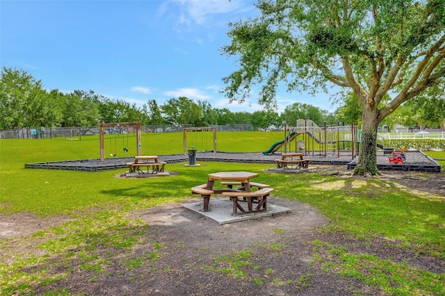 community playground with a lawn and fence