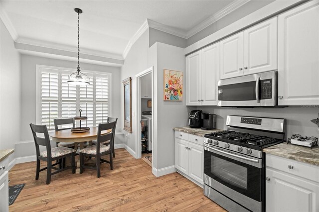 kitchen featuring crown molding, white cabinetry, appliances with stainless steel finishes, and light wood-type flooring