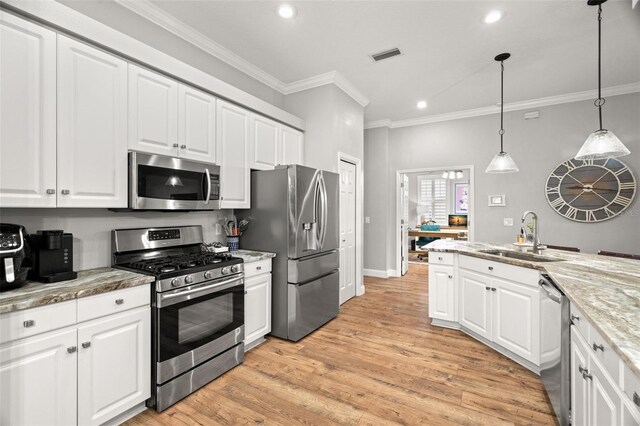 kitchen featuring crown molding, appliances with stainless steel finishes, a sink, recessed lighting, and white cabinetry