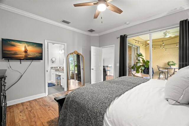 bedroom with crown molding, baseboards, wood finished floors, and visible vents