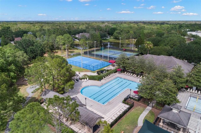 drone / aerial view featuring a water view and a wooded view