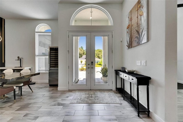 entryway with french doors and baseboards