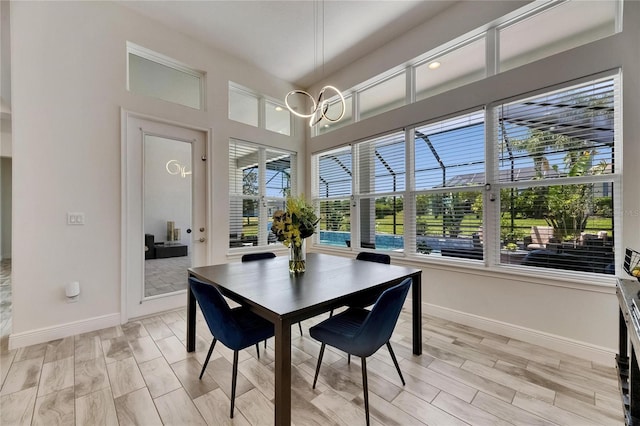 dining room with baseboards and a chandelier