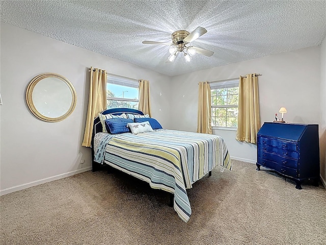 5100 Aragon Way S, Saint Petersburg, FL 33705 - bedroom with multiple windows, a textured ceiling, baseboards, and carpet floors
