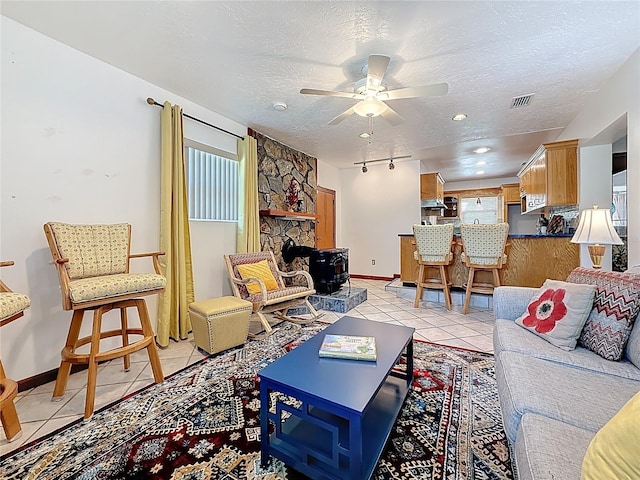 5100 Aragon Way S, Saint Petersburg, FL 33705 - living room with baseboards, ceiling fan, light tile patterned flooring, and a textured ceiling