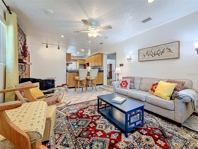 5100 Aragon Way S, Saint Petersburg, FL 33705 - living room featuring ceiling fan, a textured ceiling, light tile patterned floors, and recessed lighting