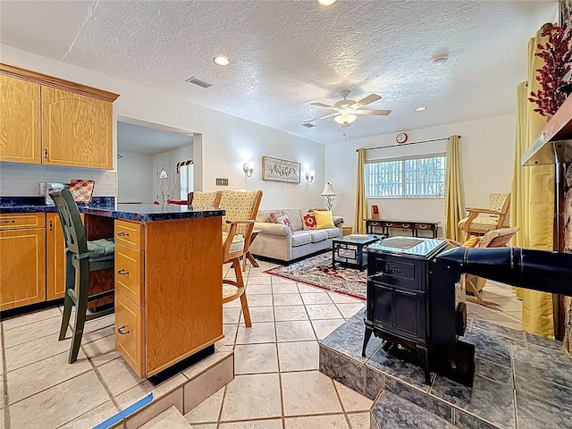 5100 Aragon Way S, Saint Petersburg, FL 33705 - kitchen featuring dark countertops, a textured ceiling, visible vents, ceiling fan, and decorative backsplash