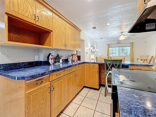 5100 Aragon Way S, Saint Petersburg, FL 33705 - kitchen featuring a peninsula, a textured ceiling, decorative backsplash, a ceiling fan, and light tile patterned floors