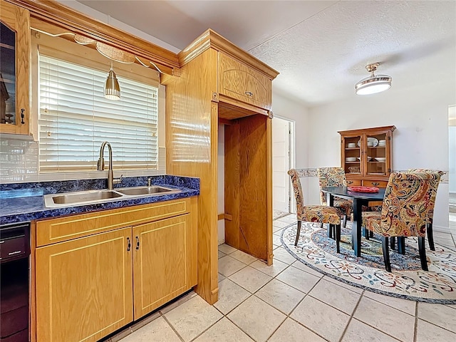 5100 Aragon Way S, Saint Petersburg, FL 33705 - kitchen with a sink, light tile patterned flooring, a textured ceiling, and dark countertops