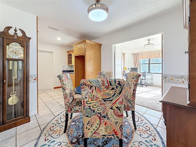 5100 Aragon Way S, Saint Petersburg, FL 33705 - dining space featuring a textured ceiling, light tile patterned flooring, and visible vents