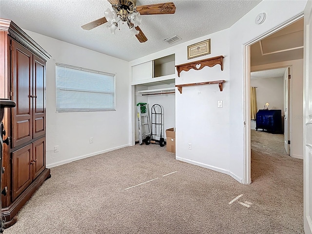 5100 Aragon Way S, Saint Petersburg, FL 33705 - unfurnished bedroom featuring light colored carpet, a textured ceiling, and a closet