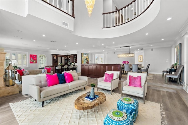 429 St Andrews Dr, Belleair, FL 33756 - living room with wood finished floors, healthy amount of natural light, ornamental molding, recessed lighting, and a chandelier