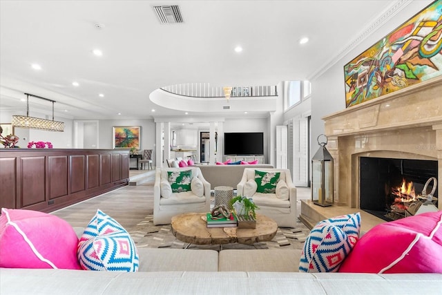 429 St Andrews Dr, Belleair, FL 33756 - living room featuring recessed lighting, wood finished floors, a high end fireplace, and crown molding
