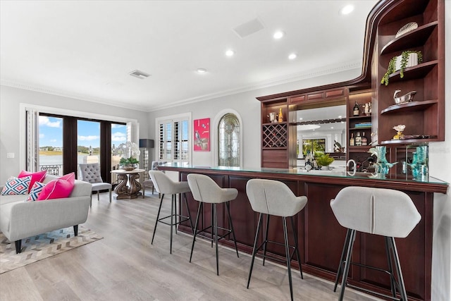 429 St Andrews Dr, Belleair, FL 33756 - indoor wet bar with crown molding, light wood-style floors, and recessed lighting
