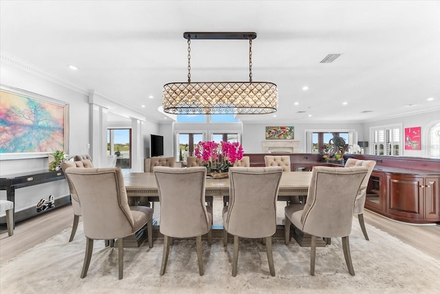 429 St Andrews Dr, Belleair, FL 33756 - dining area with ornamental molding, recessed lighting, plenty of natural light, and light wood finished floors