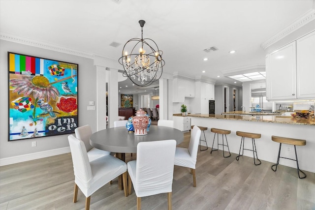 429 St Andrews Dr, Belleair, FL 33756 - dining area with a chandelier, light wood finished floors, recessed lighting, baseboards, and crown molding