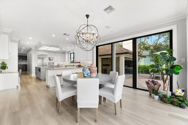 429 St Andrews Dr, Belleair, FL 33756 - dining space featuring crown molding, a chandelier, light wood-type flooring, and recessed lighting
