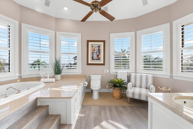 429 St Andrews Dr, Belleair, FL 33756 - bathroom featuring wood finished floors, ceiling fan, healthy amount of natural light, and vanity