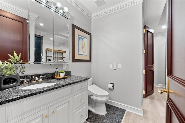 429 St Andrews Dr, Belleair, FL 33756 - bathroom featuring ornamental molding, toilet, vanity, wood finished floors, and baseboards