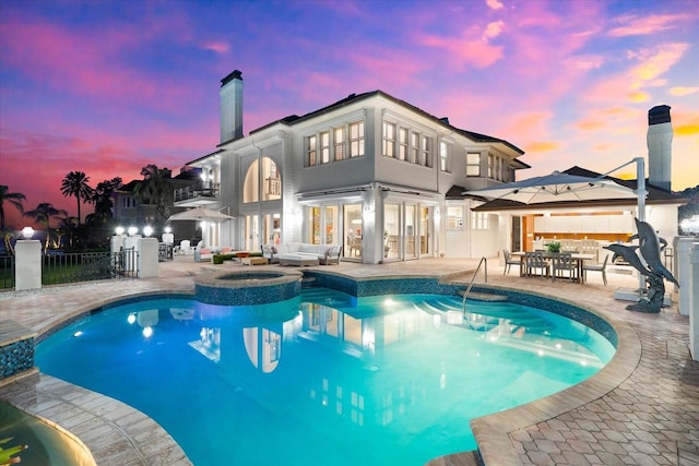 429 St Andrews Dr, Belleair, FL 33756 - back of property with outdoor lounge area, a chimney, a patio, a balcony, and a pool with connected hot tub