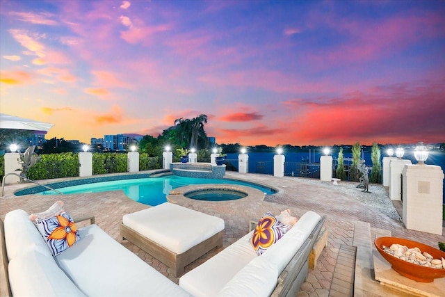 429 St Andrews Dr, Belleair, FL 33756 - pool at dusk featuring an in-ground hot tub, an outdoor living space, and a patio area