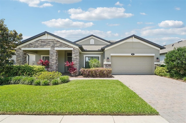 1741 Cherry Walk Rd, Lutz, FL 33558 - craftsman-style home featuring stucco siding, decorative driveway, stone siding, a front lawn, and an attached garage