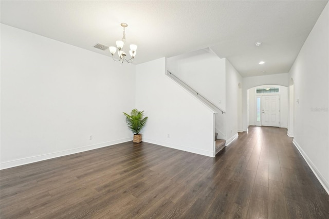 1741 Cherry Walk Rd, Lutz, FL 33558 - interior space featuring dark wood-style floors, a notable chandelier, stairs, visible vents, and arched walkways