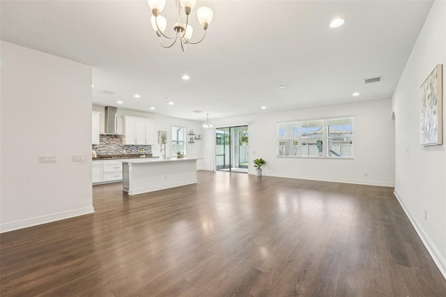 1741 Cherry Walk Rd, Lutz, FL 33558 - unfurnished living room featuring an inviting chandelier, dark wood-style flooring, visible vents, and recessed lighting