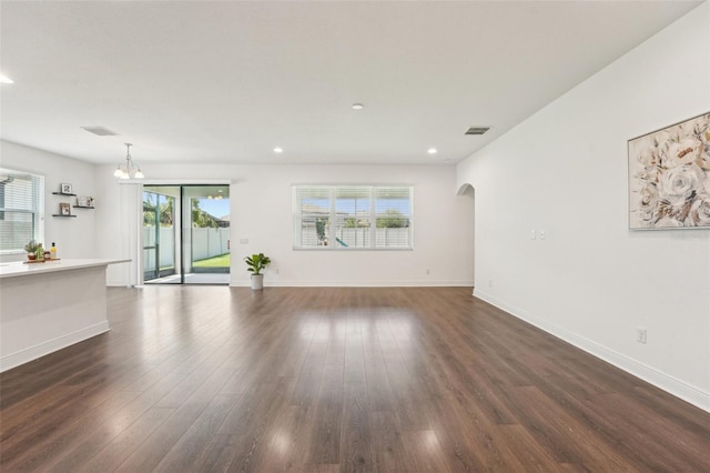 1741 Cherry Walk Rd, Lutz, FL 33558 - unfurnished living room featuring a wealth of natural light, visible vents, and dark wood-type flooring