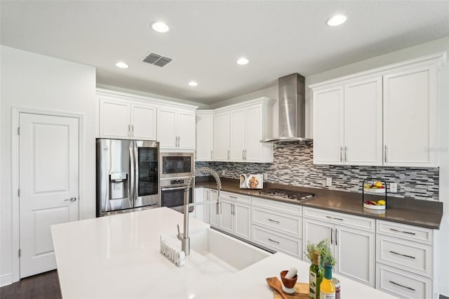 1741 Cherry Walk Rd, Lutz, FL 33558 - kitchen featuring wall chimney range hood, white cabinets, a sink, visible vents, and stainless steel appliances