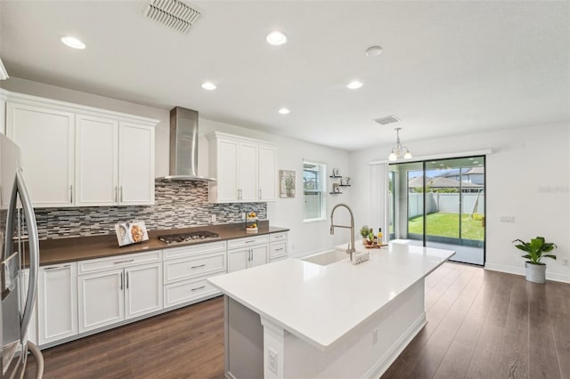 1741 Cherry Walk Rd, Lutz, FL 33558 - kitchen featuring wall chimney range hood, a sink, appliances with stainless steel finishes, visible vents, and backsplash