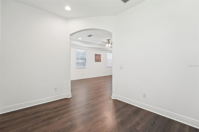 1741 Cherry Walk Rd, Lutz, FL 33558 - unfurnished room featuring ceiling fan, visible vents, baseboards, arched walkways, and dark wood finished floors