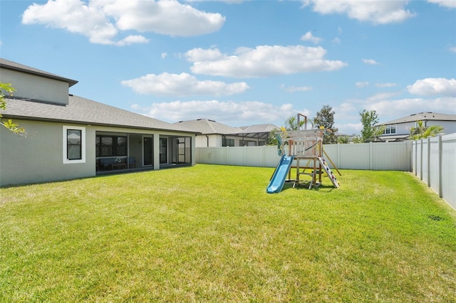1741 Cherry Walk Rd, Lutz, FL 33558 - view of yard with a fenced backyard, a playground, and a sunroom